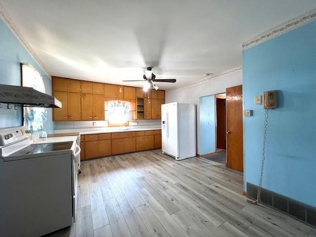 kitchen featuring light hardwood / wood-style flooring, wall chimney exhaust hood, crown molding, white appliances, and ceiling fan