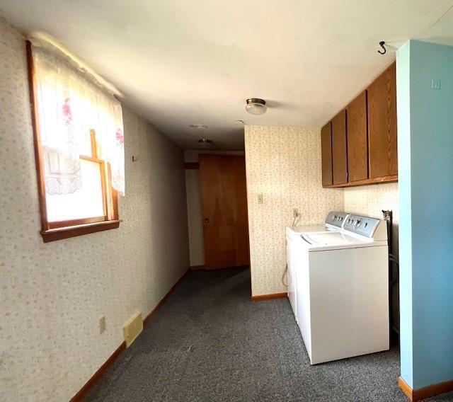 washroom with carpet floors, separate washer and dryer, and cabinets