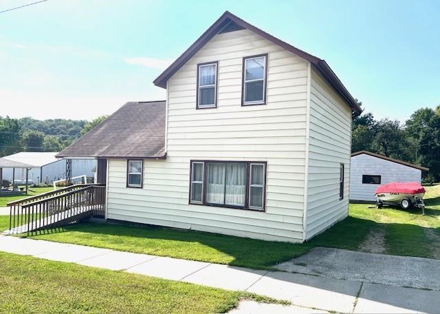 view of side of home with a yard