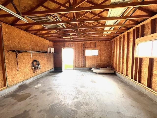 miscellaneous room featuring concrete flooring and a healthy amount of sunlight