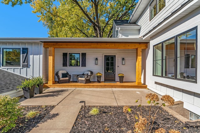 property entrance with covered porch and a patio area