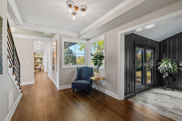 sitting room featuring crown molding, dark hardwood / wood-style floors, and vaulted ceiling