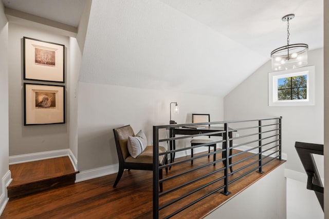 interior space with dark hardwood / wood-style floors and vaulted ceiling