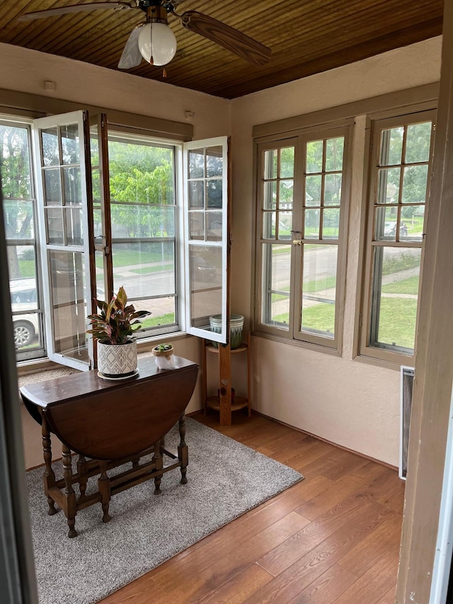 sunroom with ceiling fan, french doors, and wooden ceiling