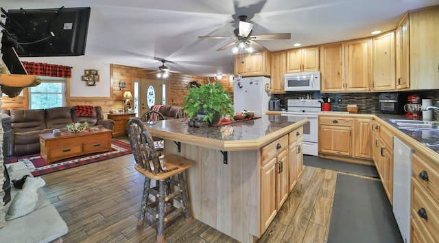 23942 Clover Dr, Merrifield, MN 56465 - kitchen with white appliances, open floor plan, a ceiling fan, a kitchen breakfast bar, and wood finished floors