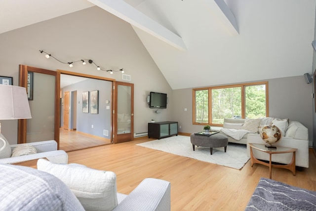 living area with light wood-type flooring, visible vents, high vaulted ceiling, baseboards, and baseboard heating