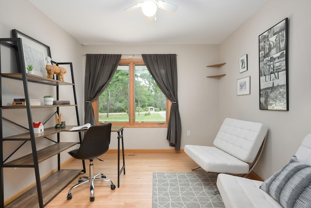 office space with wood finished floors, baseboards, and ceiling fan