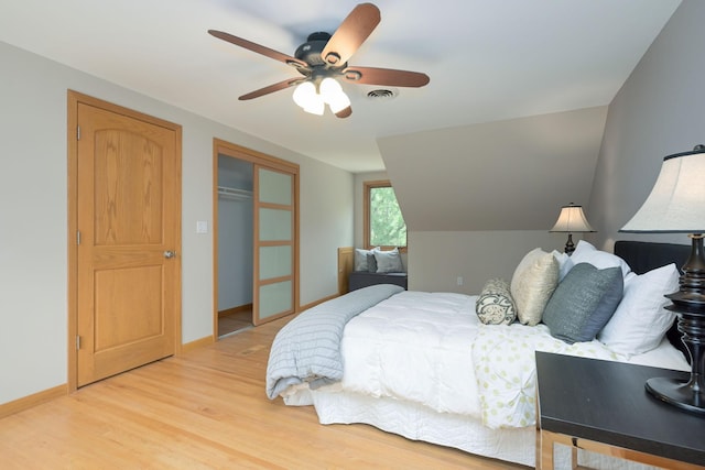 bedroom with visible vents, baseboards, light wood-type flooring, a closet, and a ceiling fan