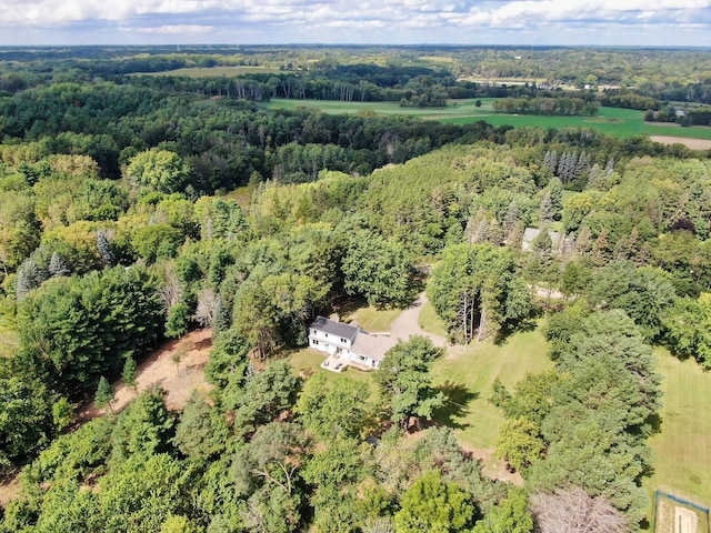 bird's eye view with a wooded view