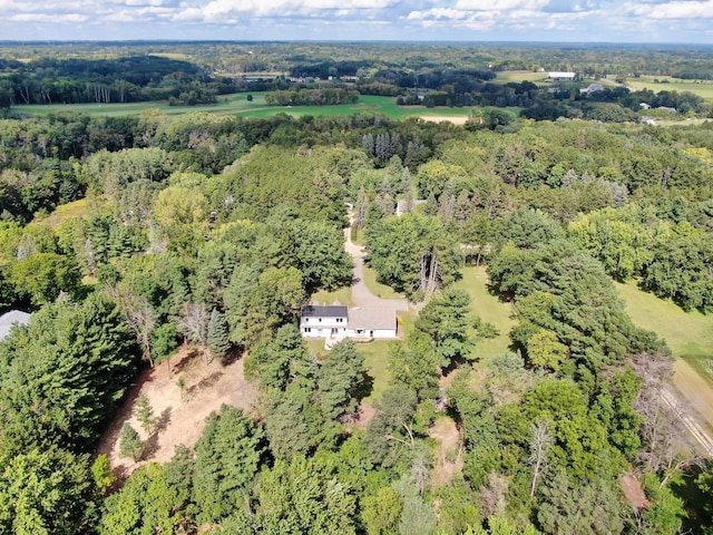 drone / aerial view with a wooded view