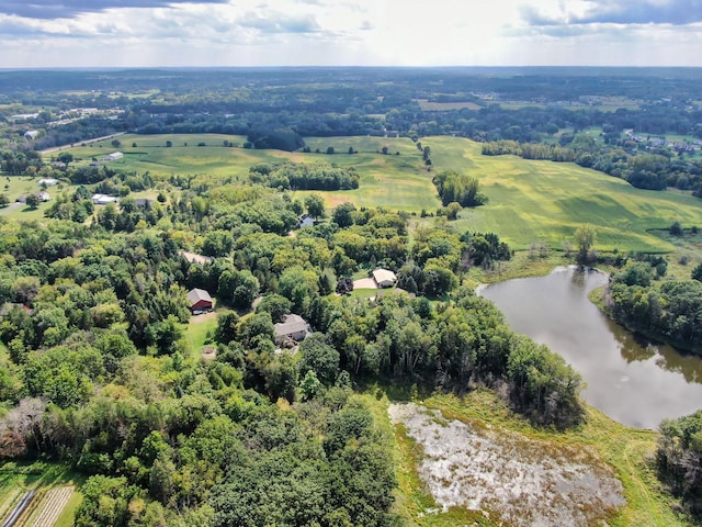 birds eye view of property with a forest view and a water view