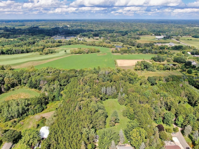 aerial view featuring a wooded view