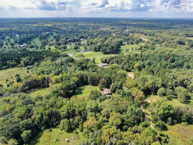 drone / aerial view with a wooded view