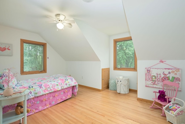 bedroom featuring lofted ceiling, wood finished floors, baseboards, and ceiling fan