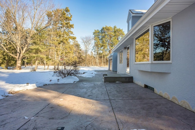 exterior space featuring a patio and stucco siding