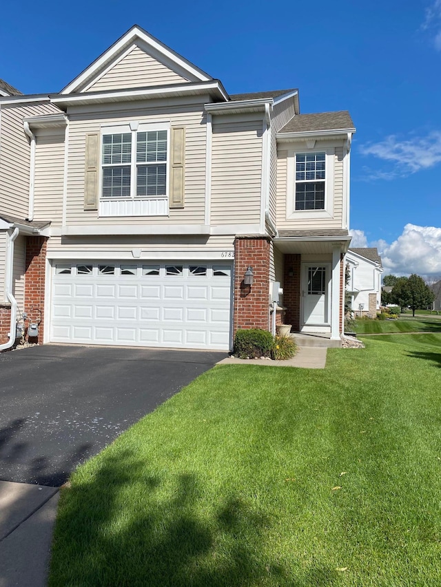 view of front of home featuring a garage and a front yard