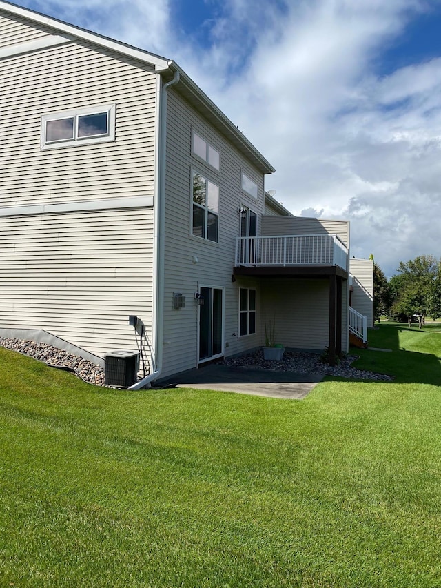 back of house with a patio area, central AC unit, and a lawn