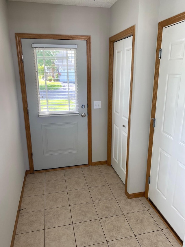 entryway featuring light tile patterned flooring