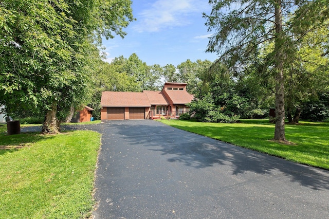 view of front facade with a garage, driveway, and a front lawn