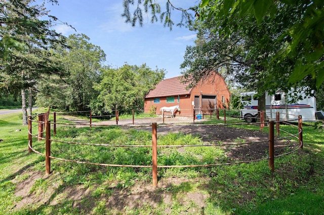 view of yard featuring fence and an outdoor structure