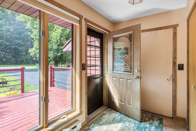 doorway to outside with light tile patterned floors