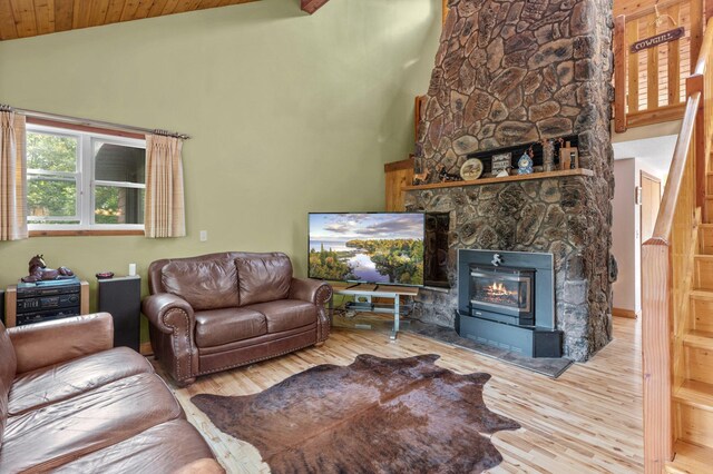 living room with a fireplace, high vaulted ceiling, wood ceiling, and wood-type flooring