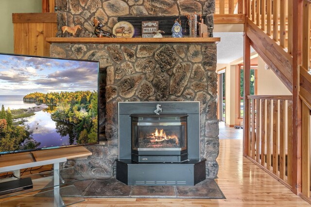 room details featuring hardwood / wood-style floors and a stone fireplace