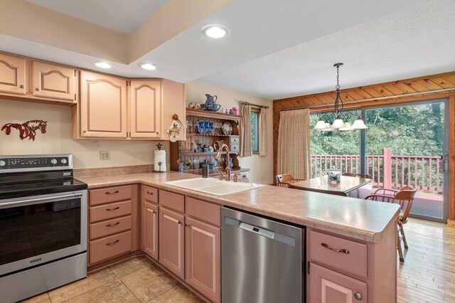 kitchen with sink, kitchen peninsula, and stainless steel appliances