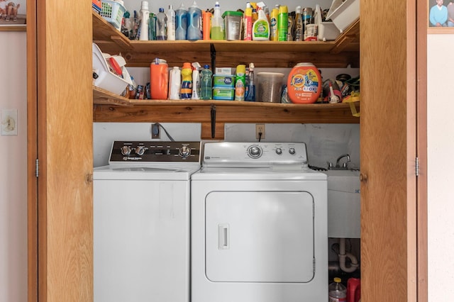 laundry room with washing machine and dryer and a sink