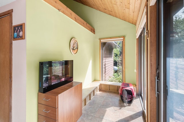 living room with light tile patterned floors, wood ceiling, and vaulted ceiling