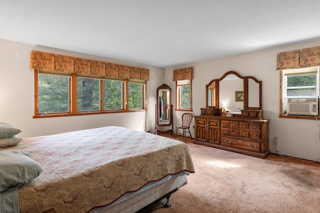 bedroom featuring carpet floors, a textured ceiling, and cooling unit