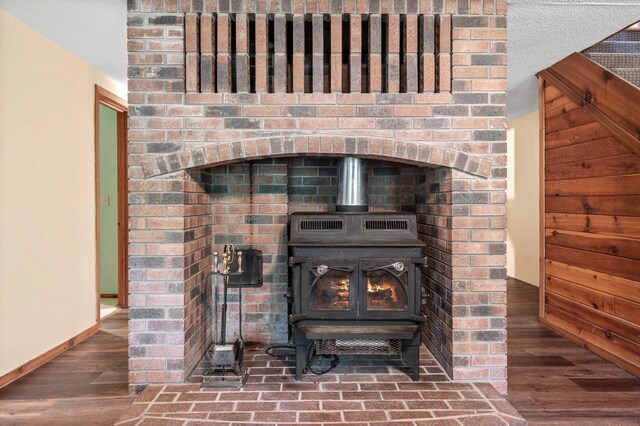 details featuring hardwood / wood-style flooring and a wood stove