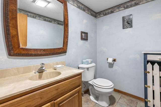 bathroom featuring tile patterned flooring, vanity, toilet, and a textured ceiling