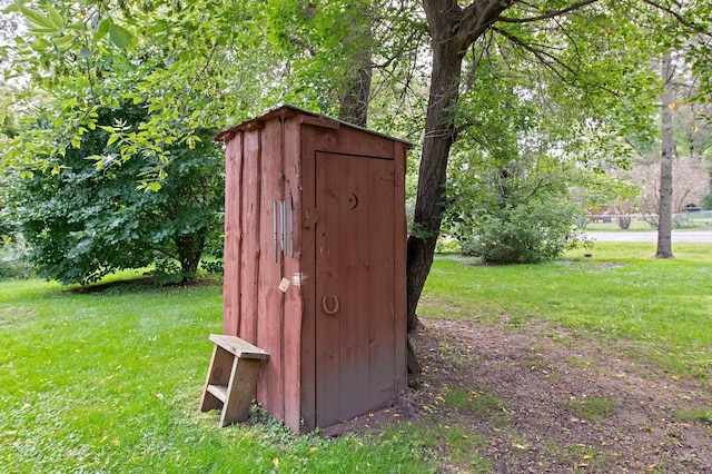 view of outbuilding with a lawn