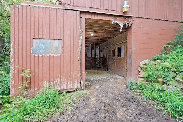 view of property exterior featuring an outbuilding and concrete block siding