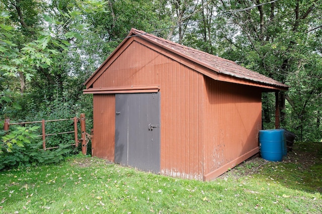 view of shed featuring fence