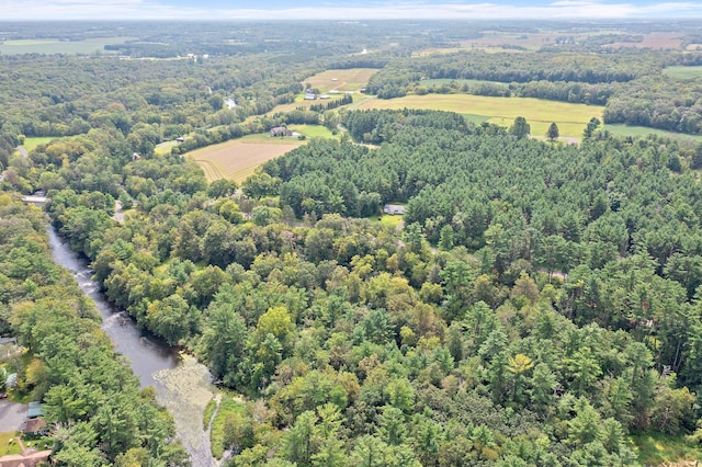 birds eye view of property featuring a view of trees