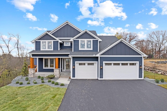 craftsman-style home featuring a front lawn, a porch, and a garage