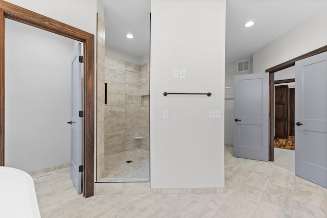 bathroom featuring a shower with shower door