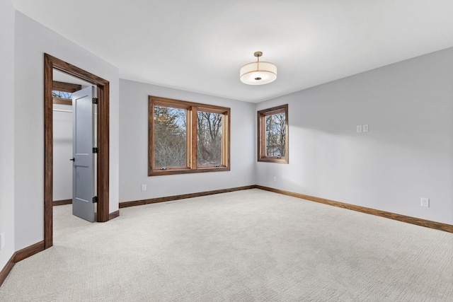 unfurnished room featuring light carpet