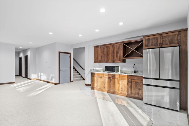 kitchen featuring light colored carpet, sink, and appliances with stainless steel finishes