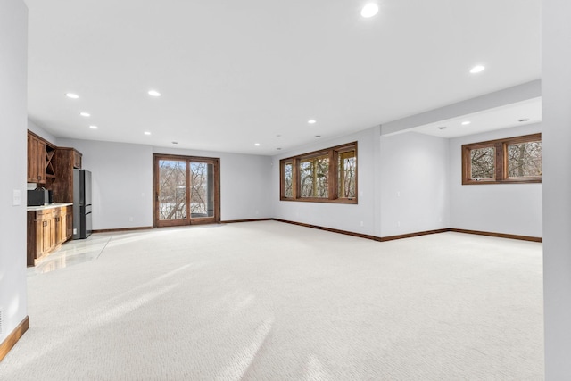 unfurnished living room with light colored carpet