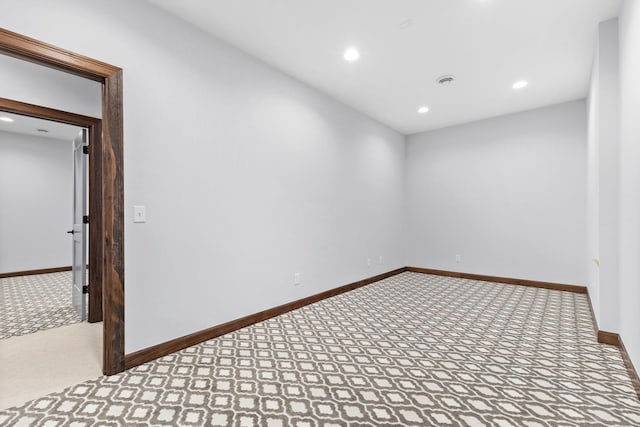 unfurnished room with light carpet