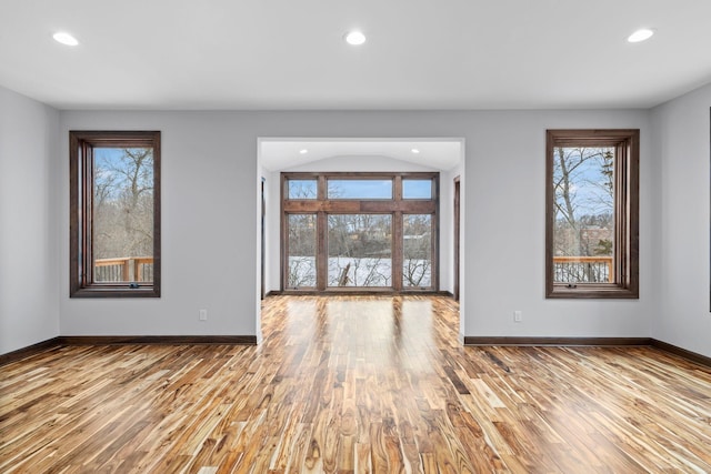 unfurnished living room with lofted ceiling and light hardwood / wood-style flooring