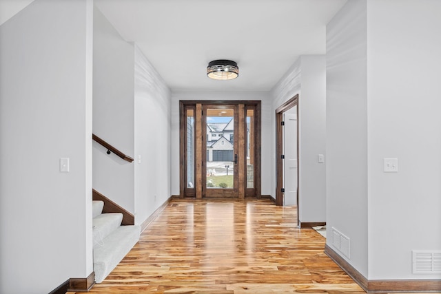 5534 Conifer Trl, Minnetonka, MN 55345 - foyer with light wood-style floors, stairway, and baseboards