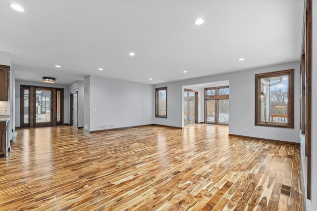 5534 Conifer Trl, Minnetonka, MN 55345 - unfurnished living room with light wood finished floors, healthy amount of natural light, recessed lighting, and baseboards