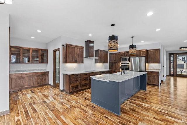5534 Conifer Trl, Minnetonka, MN 55345 - kitchen with stainless steel appliances, premium range hood, light wood-style floors, recessed lighting, and a sink