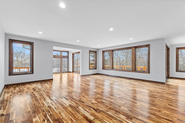 5534 Conifer Trl, Minnetonka, MN 55345 - unfurnished living room with wood finished floors, baseboards, healthy amount of natural light, and recessed lighting
