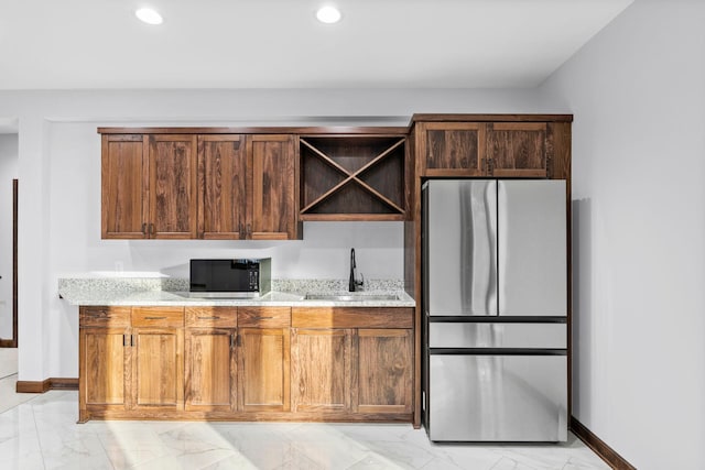 5534 Conifer Trl, Minnetonka, MN 55345 - kitchen featuring freestanding refrigerator, a sink, light marble finish floors, baseboards, and light stone countertops