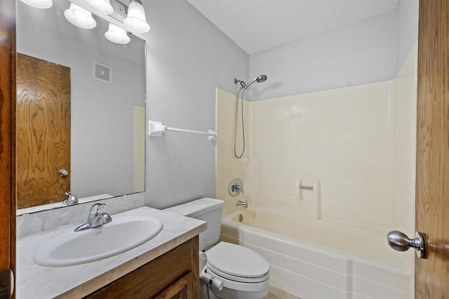 full bathroom featuring vanity, toilet, a textured ceiling, and shower / bathtub combination